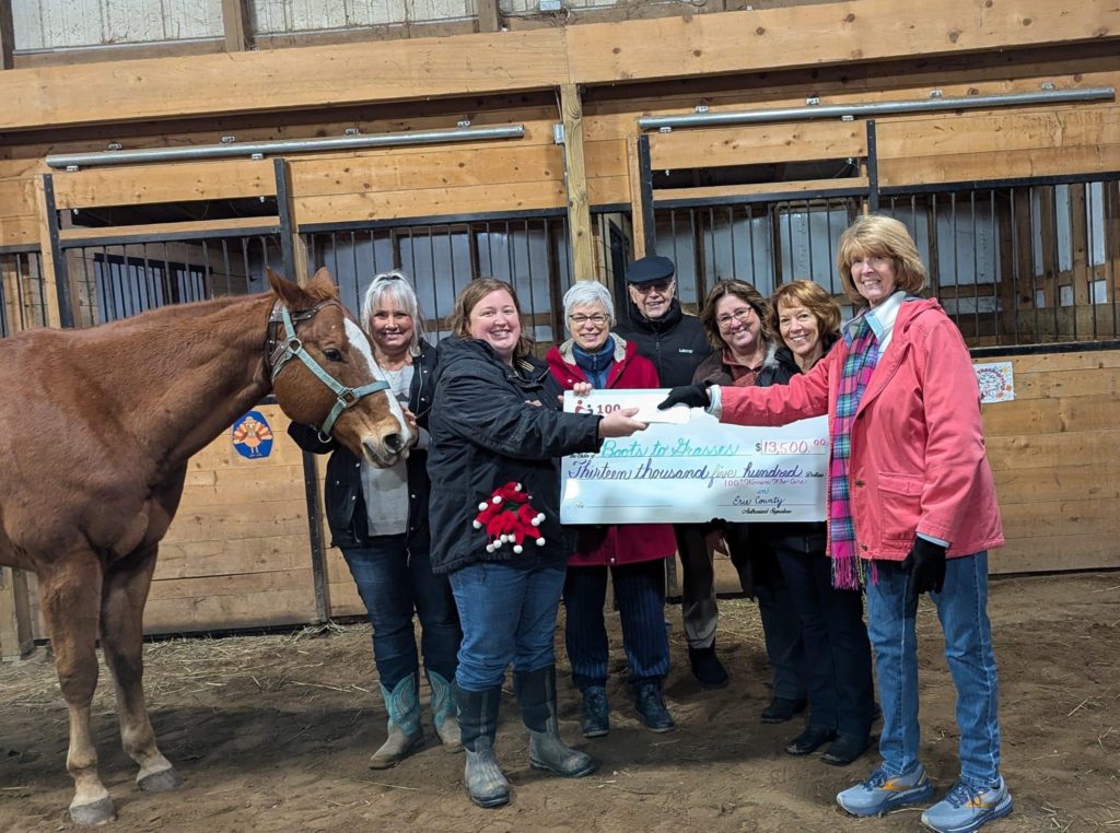 Presentation of checks to Bella and Laura from 100 Women Who Care.