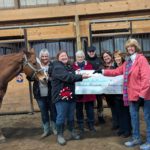 Presentation of checks to Bella and Laura from 100 Women Who Care.